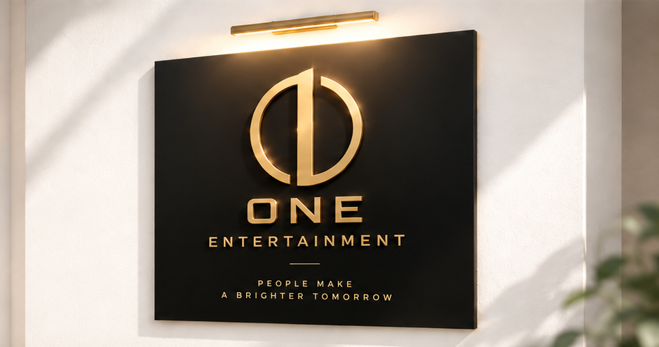 골드 ONE ENTERTAINMENT 로고가 새겨진 브랜드 명판